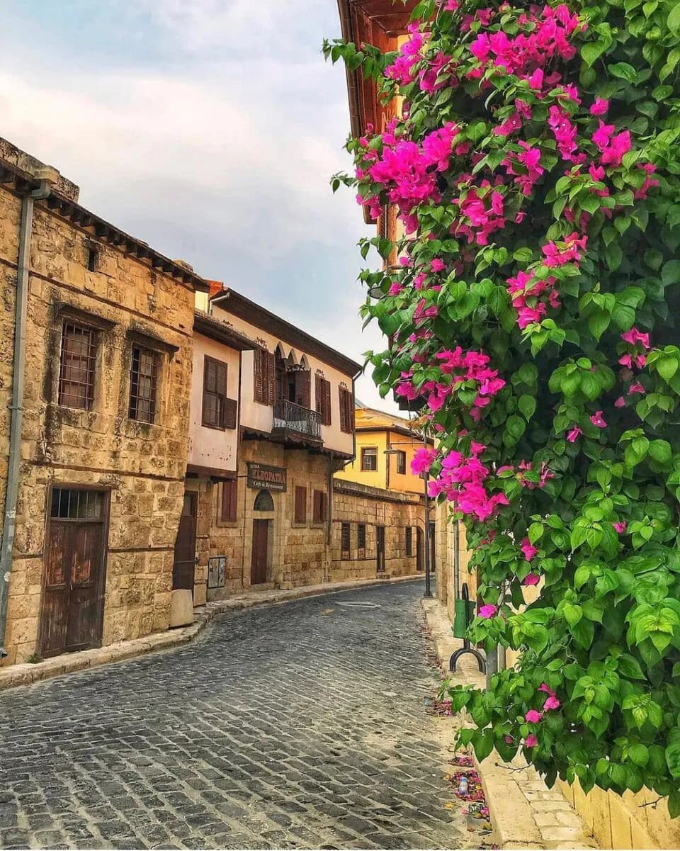 A cobbled street in the old town of Tarsus, lined with historic stone houses.